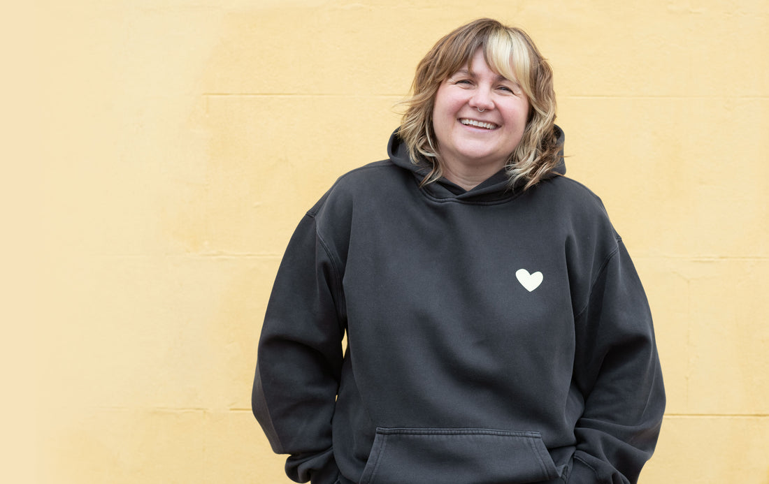 TSY Founder, Lucy is smiling into the camera, she is wearing Always Feeling All the Feelings hoodie